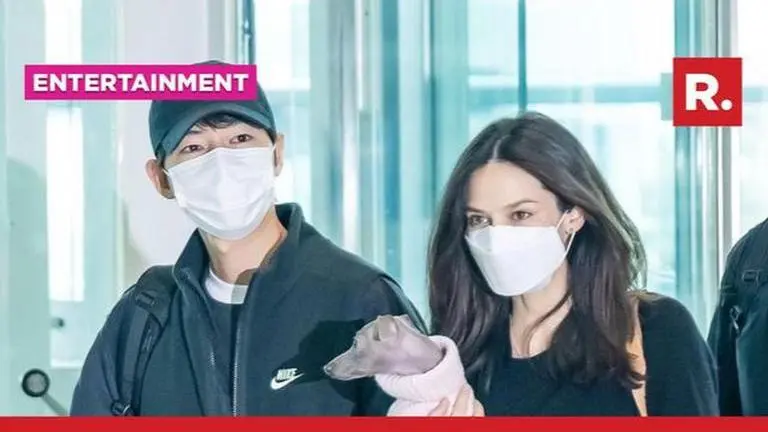 Song Joong Ki tries to protect wife Katy during first public appearance after marriage Song Joong Ki and Katy Louise Saunders