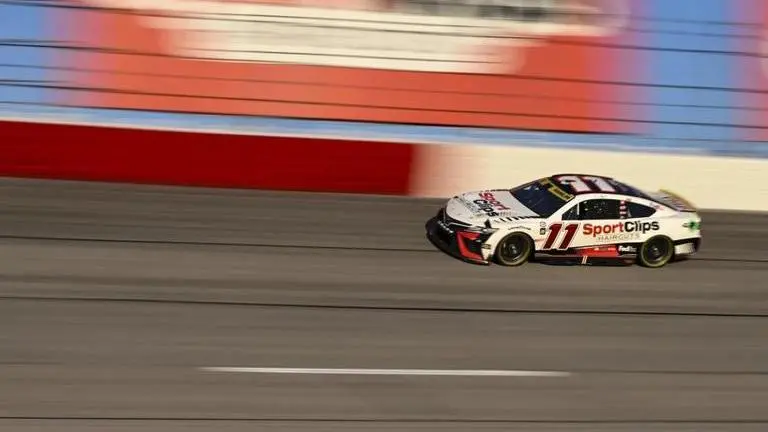 Denny Hamlin (11) competes through Turn 2 during a NASCAR Cup Series auto race at Darlington Raceway