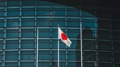 Japan's Q4 GDP revised up, economy avoids recession Japan government considers declaring end to deflation