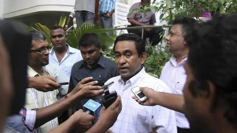 Maldives top court rejects jailed former President's plea for eligibility to run again for the office Abdullah Yameen speaks to the media outside his home in Male, Maldives