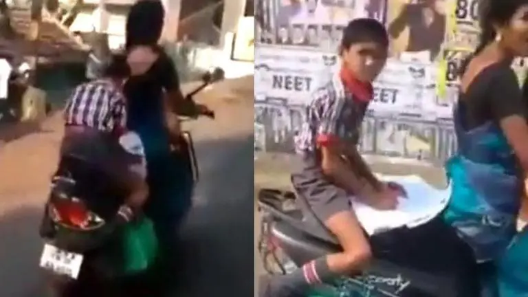 Child does homework on scooty's backseat as mother takes him to school; Watch viral video homework