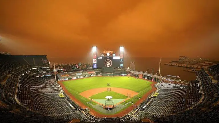 Smoke from nearby wildfires creates eerie baseball scene