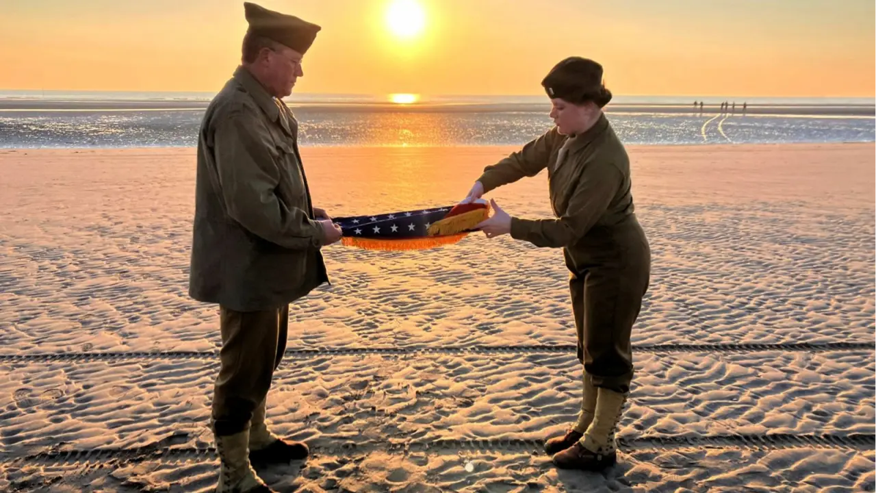 As World Marks 80th Anniversary of D-Day Landings, Renewed War in Europe Is on Minds of Many Christophe Receveur and his daughter Julie, of France, unfold an American flag he bought six month ago in Gettysburg, Penn., to mark D-Day, June 6, 2024 on Utah Beach, Normandy