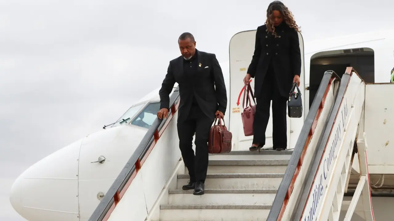 Malawi Vice President Saulos Chilima,left, and his wife Mary disembark from a plane upon his return from South Korea in Lillongwe, June 9, 2024.
