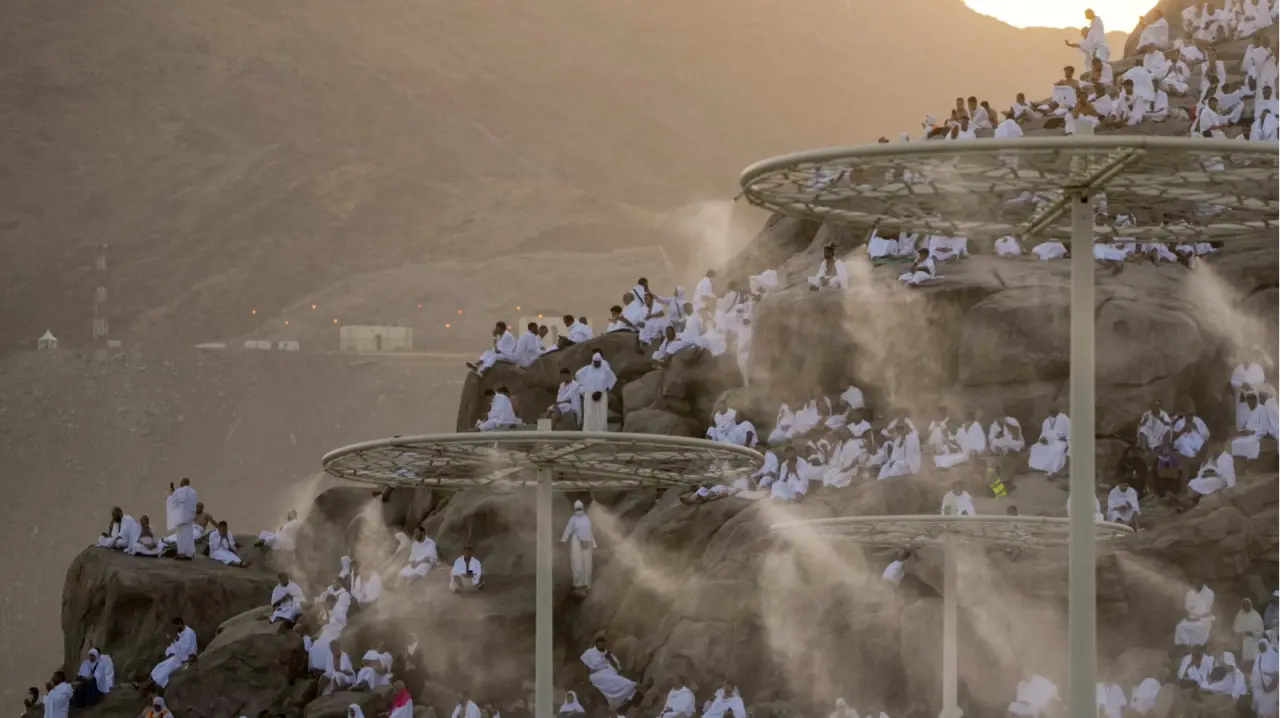 Water mist is sprayed on Muslim pilgrims as they pray on the rocky hill known as the Mountain of Mercy, on the Plain of Arafat, during the annual Hajj pilgrimage, near the holy city of Mecca on June 27, 2023.