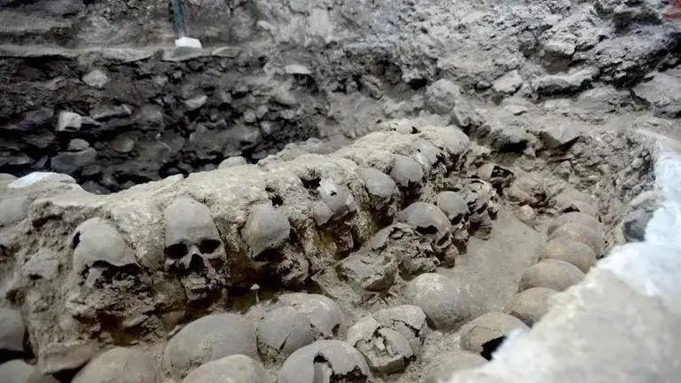 Archaeologists unearth new facade of human skull tower in Mexican capital Archaeologists unearth new facade of human skull tower in Mexican capital