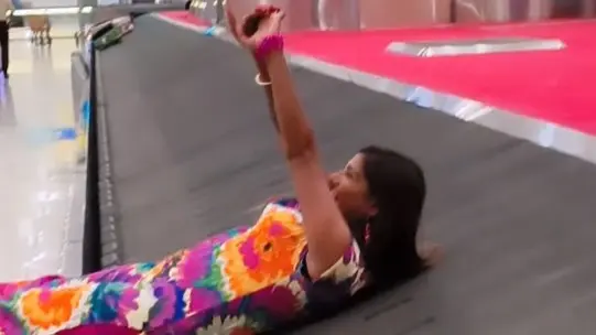 Viral Video of Woman Lying on Airport Luggage Conveyor Belt Receives Severe Backlash A screengrab from the conveyor belt video that has gone viral.