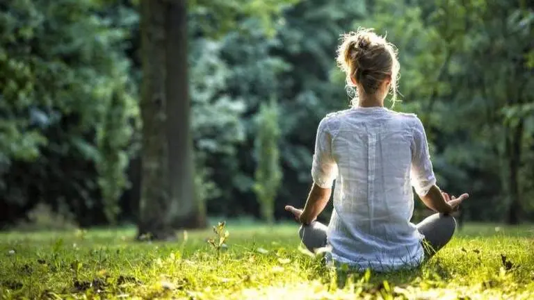 Is naturopathy an alternative to medication in mental health battle? A woman meditating amid nature | Image: iStock