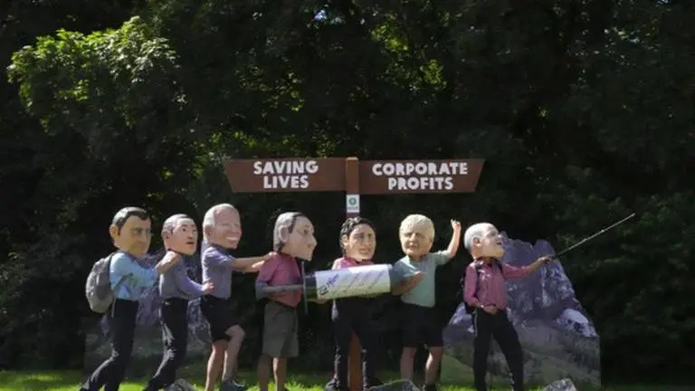 G7 protestors wear giant heads of world leaders to draw attention to climate change G7