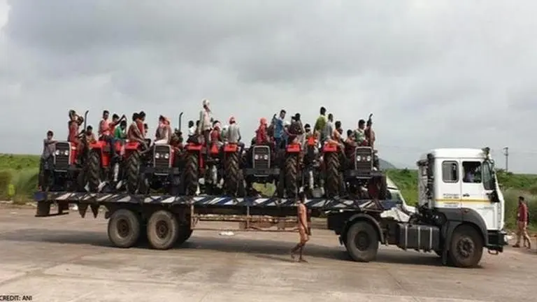 Odisha: Migrants travel on trailer truck packed with tractors to reach home amid lockdown Odisha