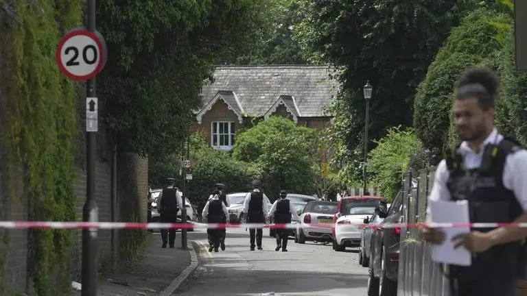 8-year-old girl in 'critical' condition after deadly school car crash jolts the London town Police officers set up cordon line after a car crashed into a primary school building in Wimbledon, London