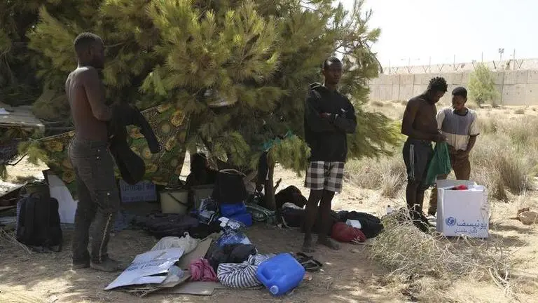 Bodies of 8 migrants have been found off the coast of port city in Tunisia after their boats sank Migrants gather in a desert area on the Libyan side of the Tunisia-Libya border