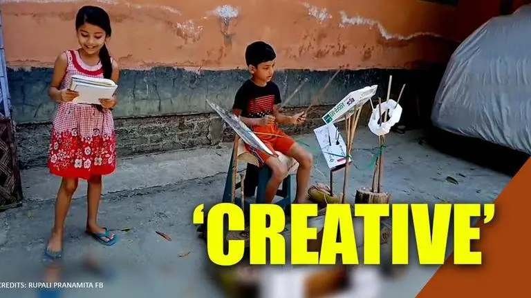 Assam: Siblings perform with drums made from cardboard and steel tray Siblings perform with drums made from cardboard and steel tray in Assam