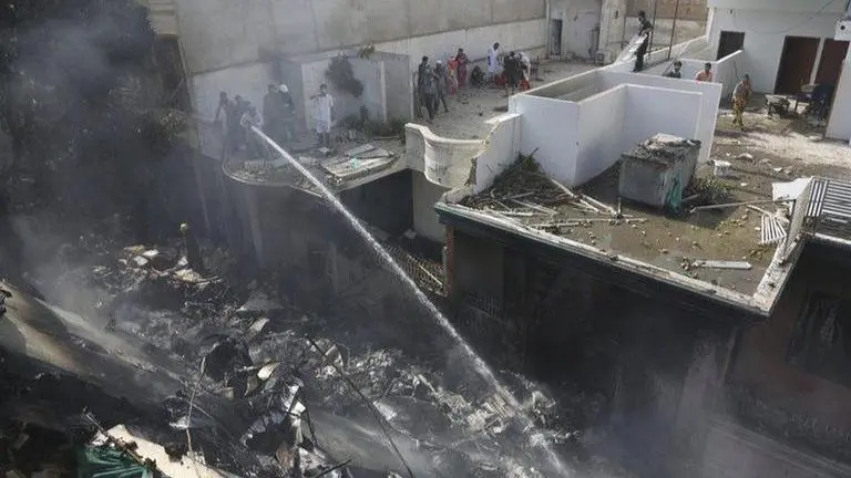 Karachi residents watch smoke from plane crash