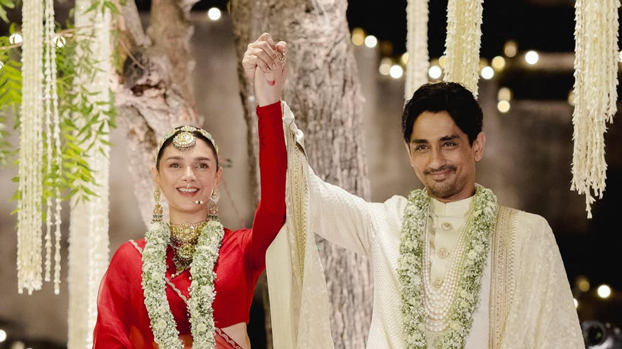 Aditi Rao Hydari and Siddharth walk the aisle hand-in-hand.