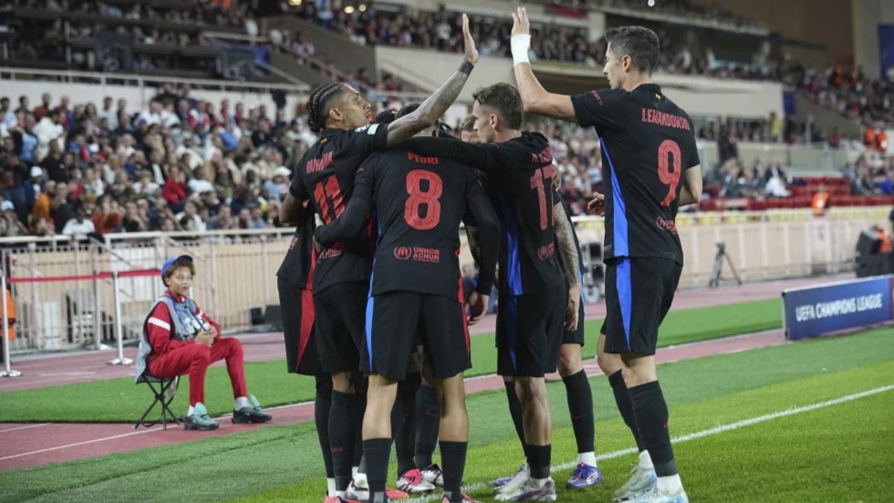 Barcelona players celebrate against Monaco.