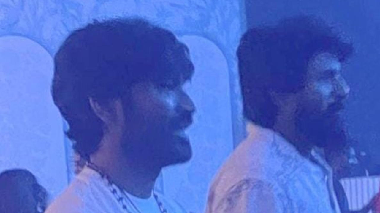 Dhanush and Siva standing together.