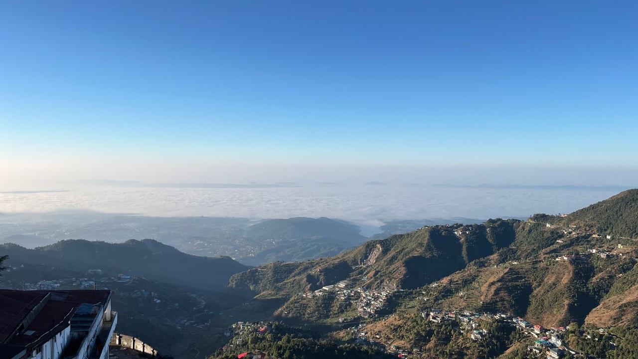 From Brentwood, the winterline in Mussoorie reveals a stunning view—a horizon glowing in warm golden tones, where the sky meets the hills.