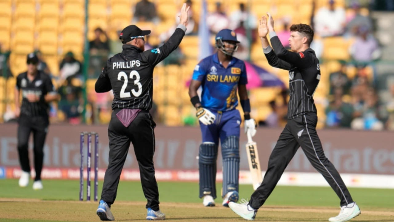 Glenn Philips and Mitchell Santner celebrate fall of a wicket