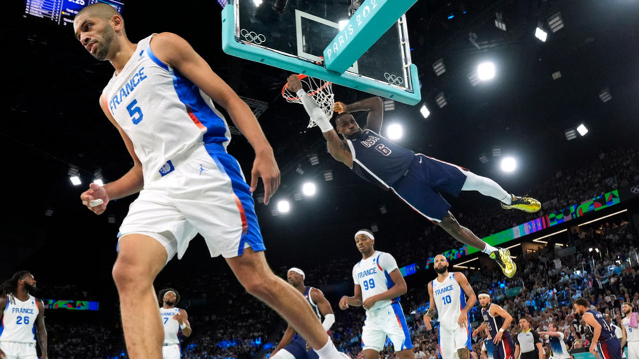 LeBron James dunks over France's Nicolas Batum during the Paris Olympics gold medal match