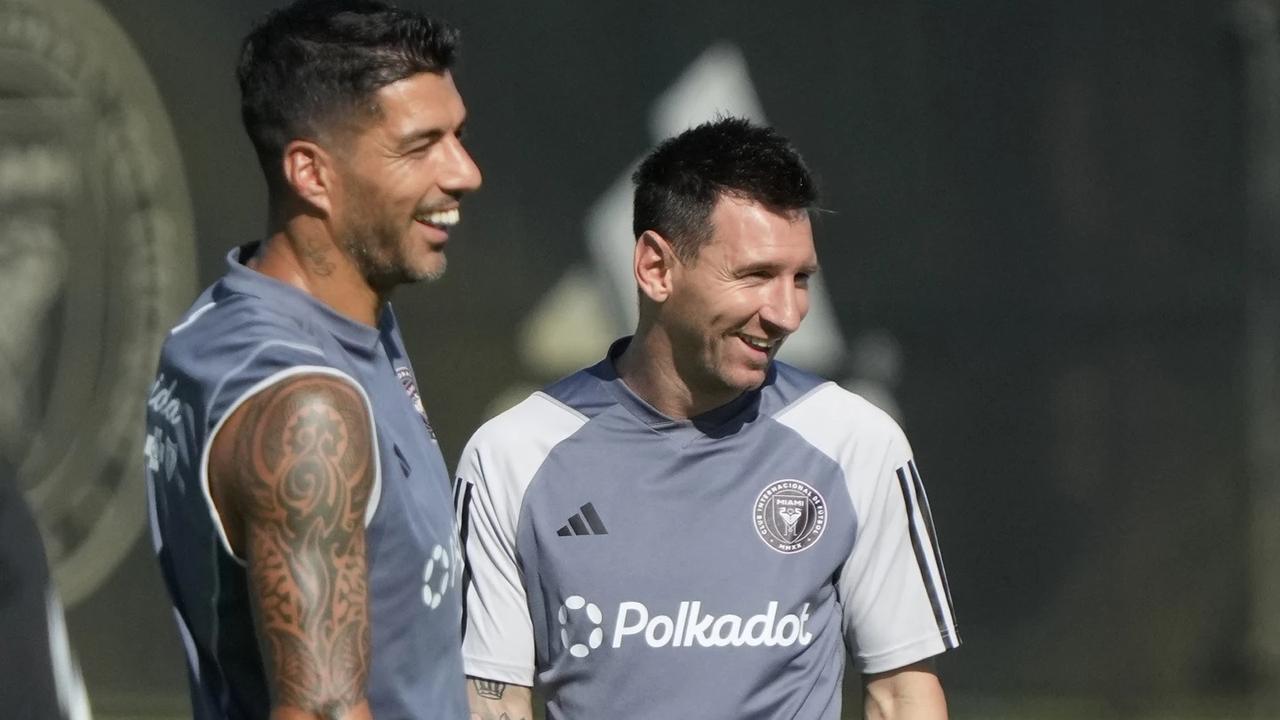 Leo Messi and Luis Suarez share a laugh in training.