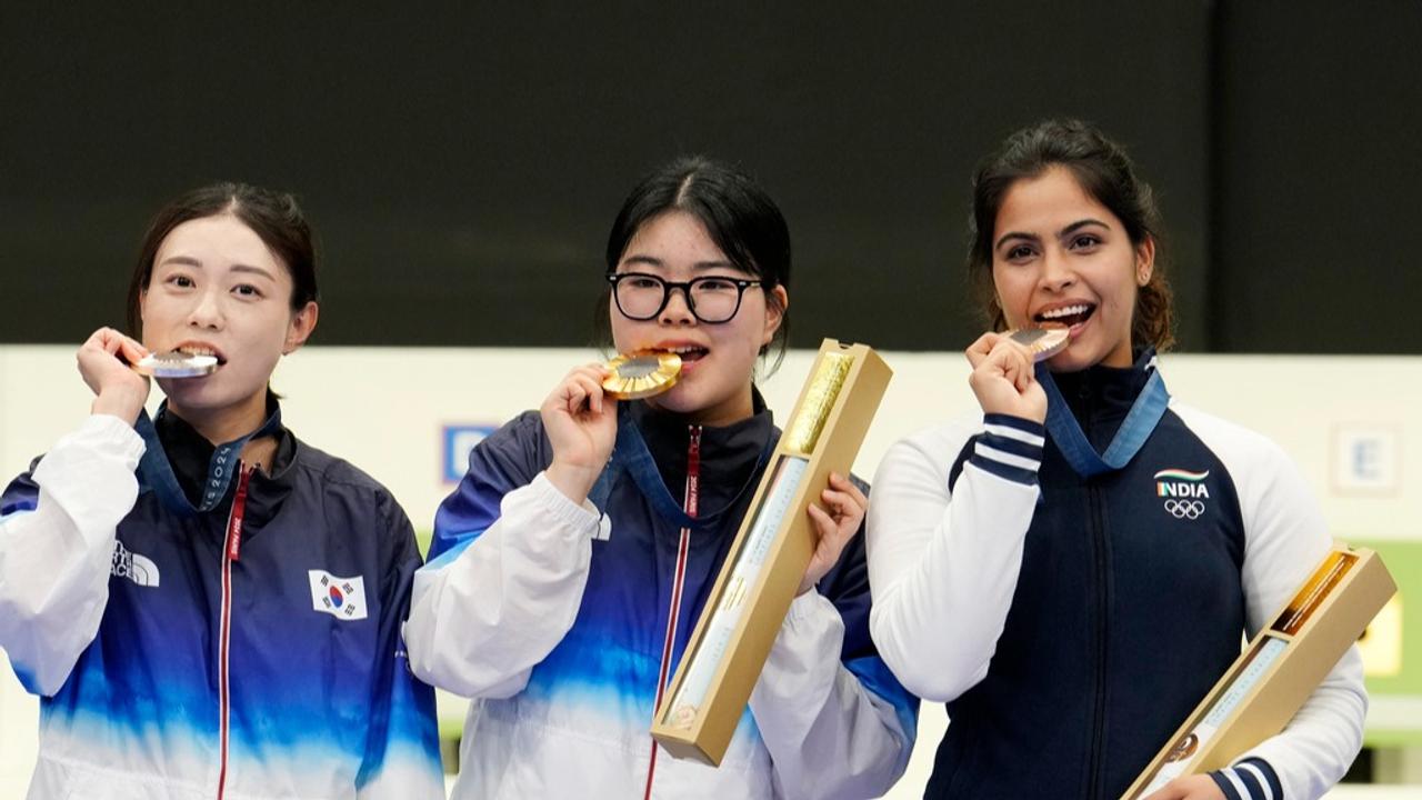 Manu Bhaker celebrates with the medal winners at Paris Olympics podium. 