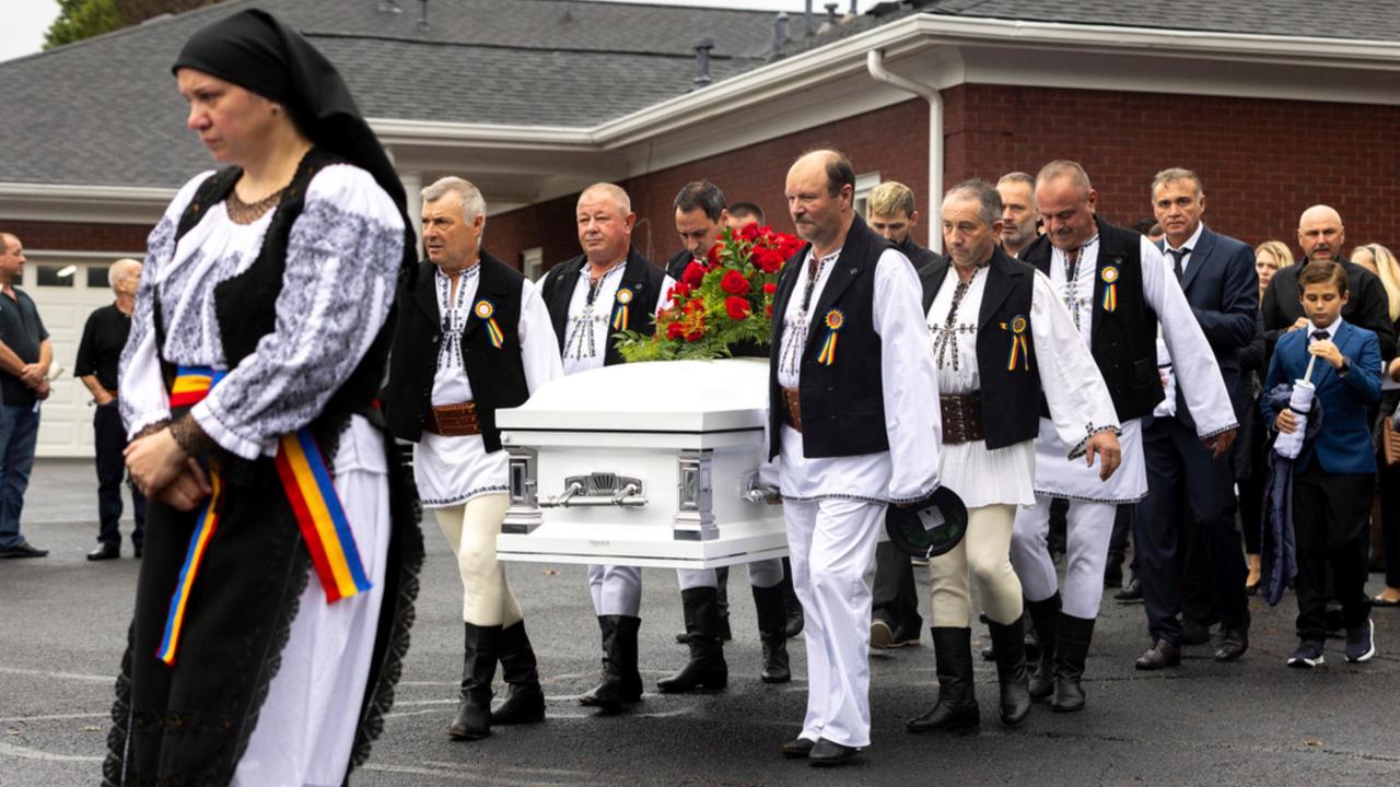 Mourners carry the casket of Ana Cristina Irimie, a math teacher killed during a shooting at Apalachee High School