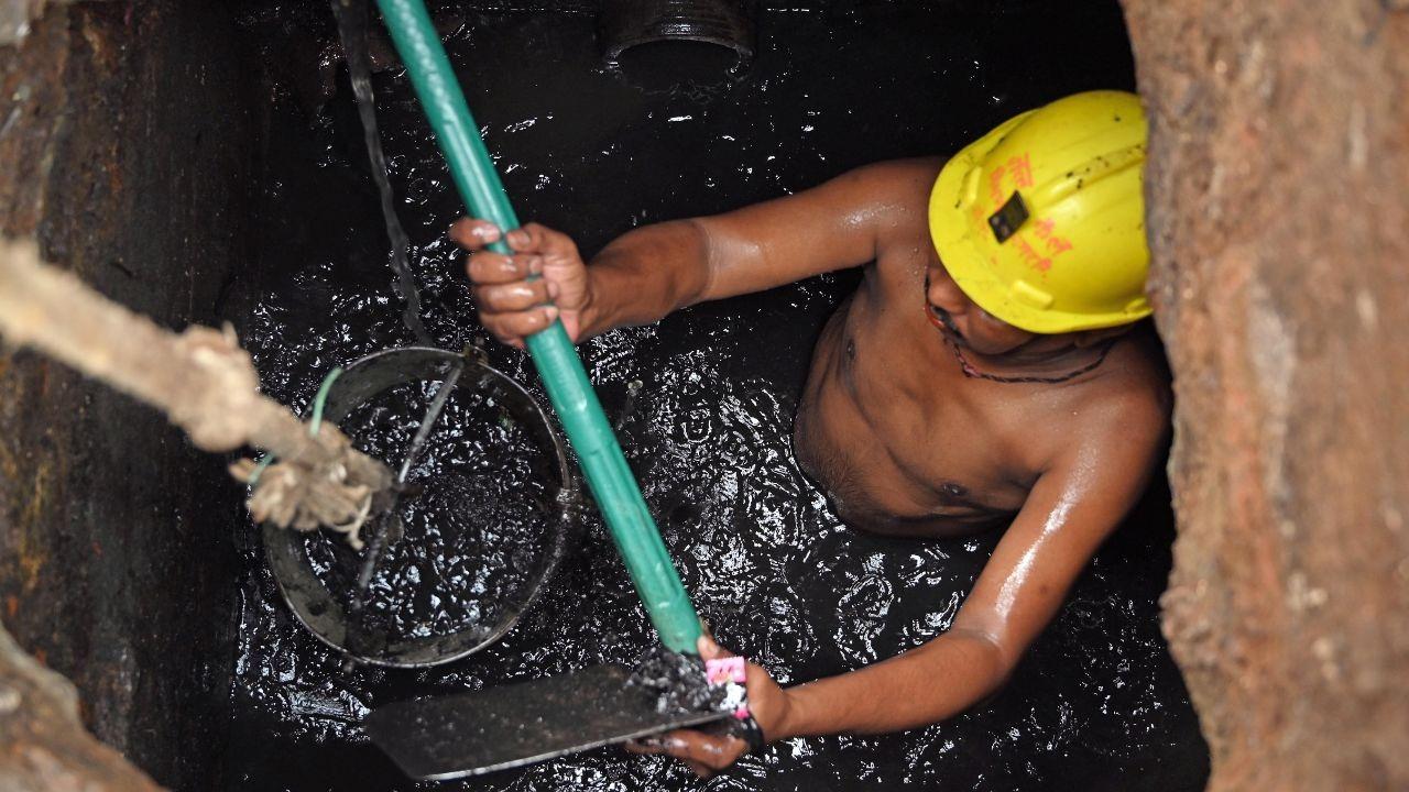 municipal corporation worker cleans the sewer