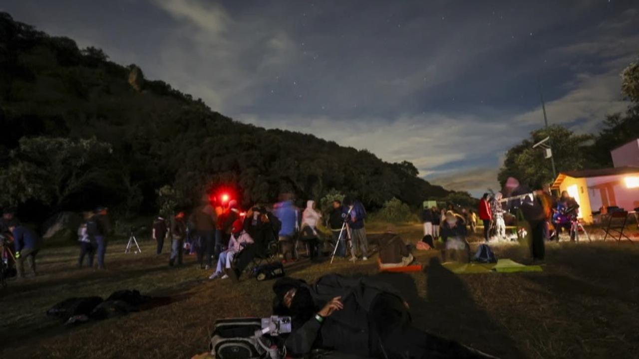 People engage in a star-garzing, comet show at at Joya-La Barreta ecological park in Queretaro, Mexico.