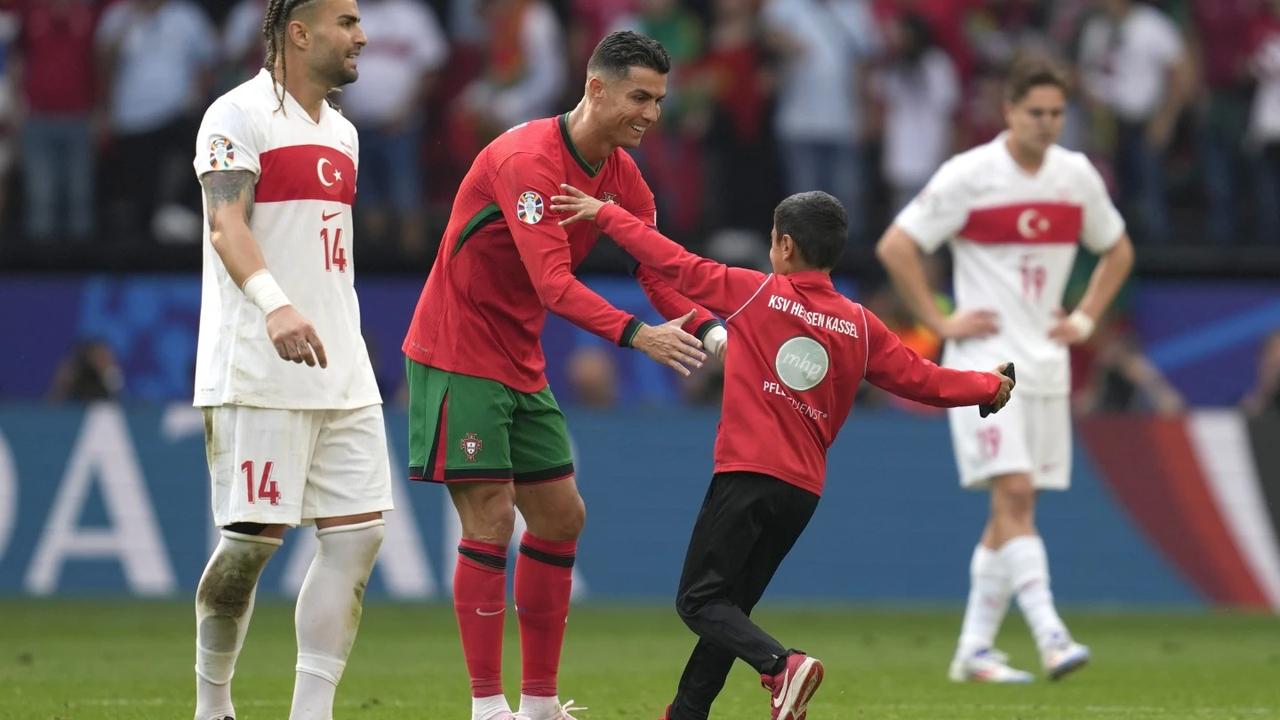 Cristiano Ronaldo with young pitch invader in Turkey vs Portugal at Euro 2024