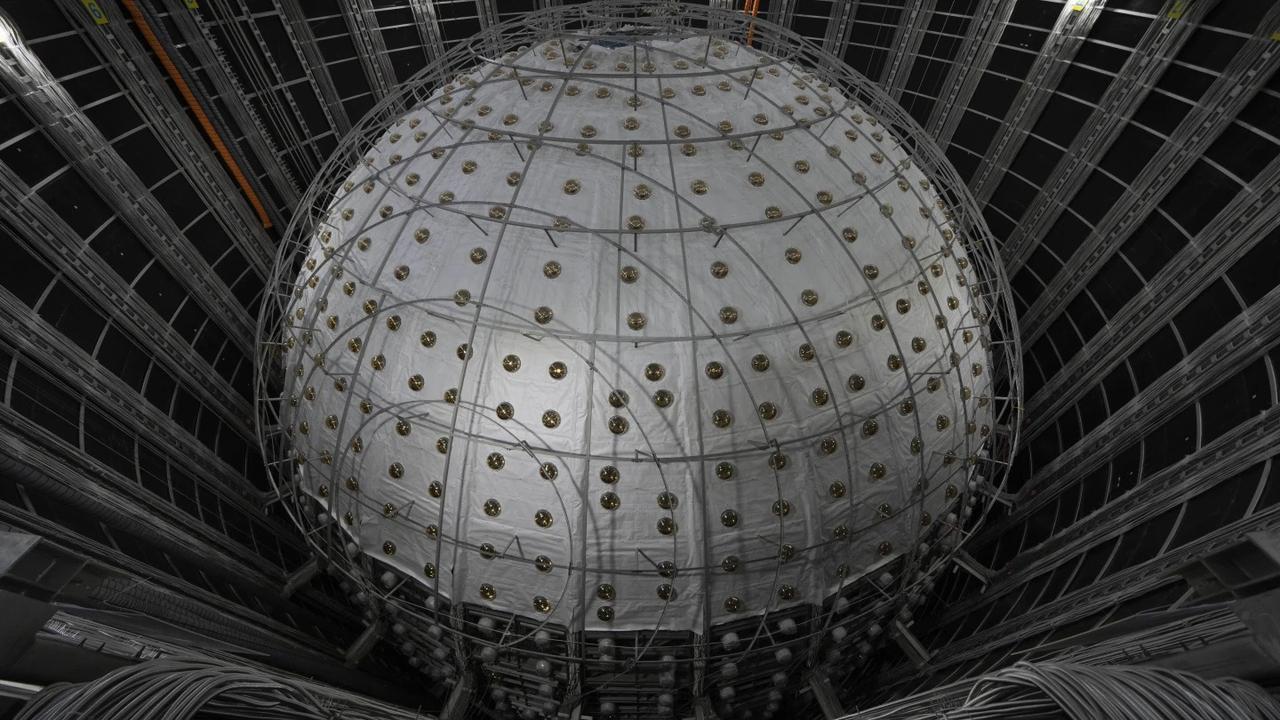  Underneath a granite hill in southern China, a massive detector is nearly complete that will sniff out the mysterious ghost particles lurking around us.