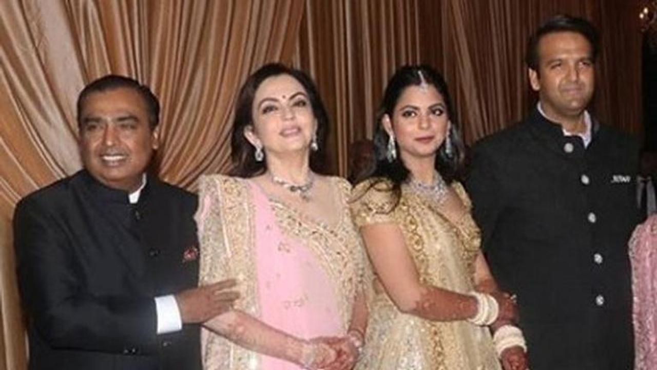 IN PICS | Newlyweds Isha Ambani-Anand Piramal arrive in style with their parents for wedding reception