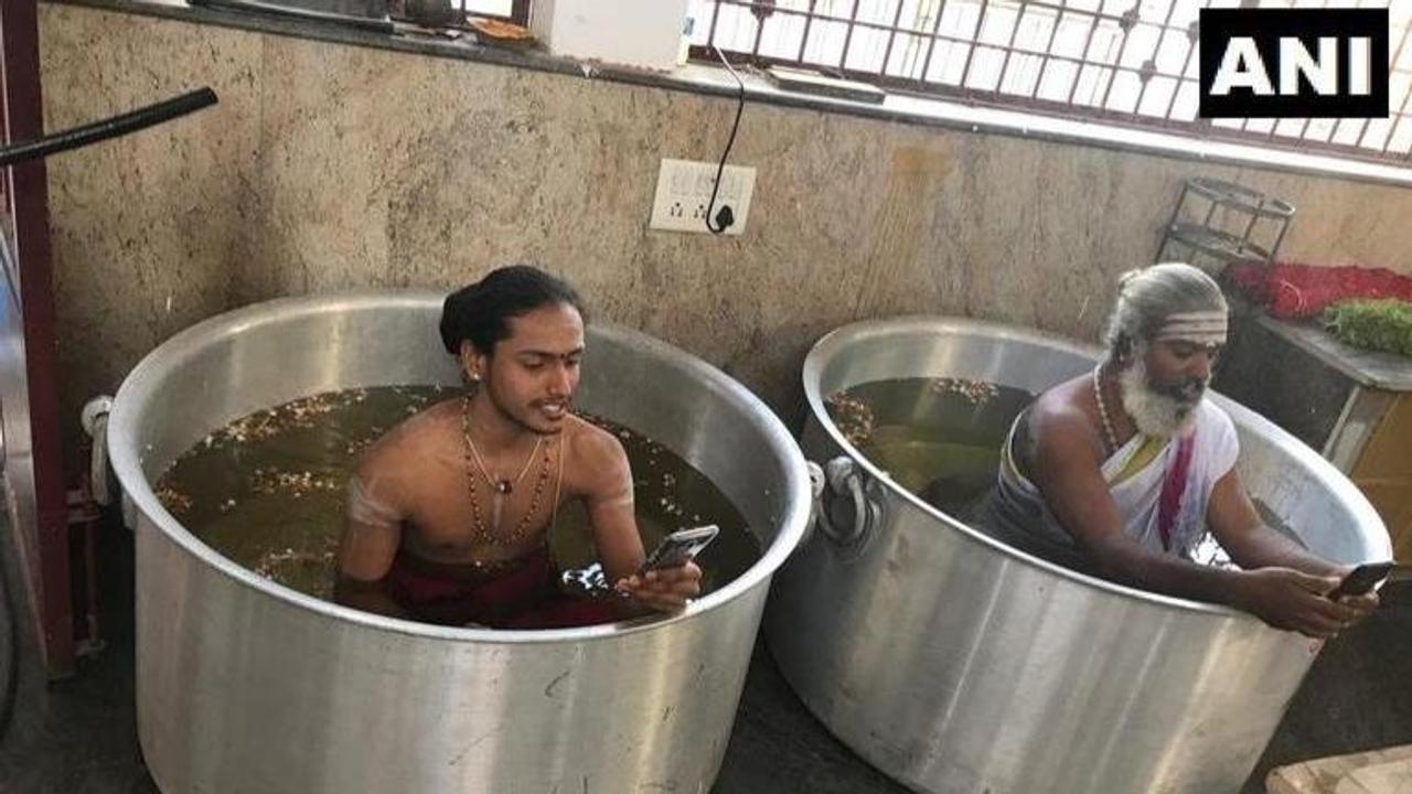 Appealing to the Rain Gods, priests in Karnataka temple perform rituals immersed in massive water-filled vessels