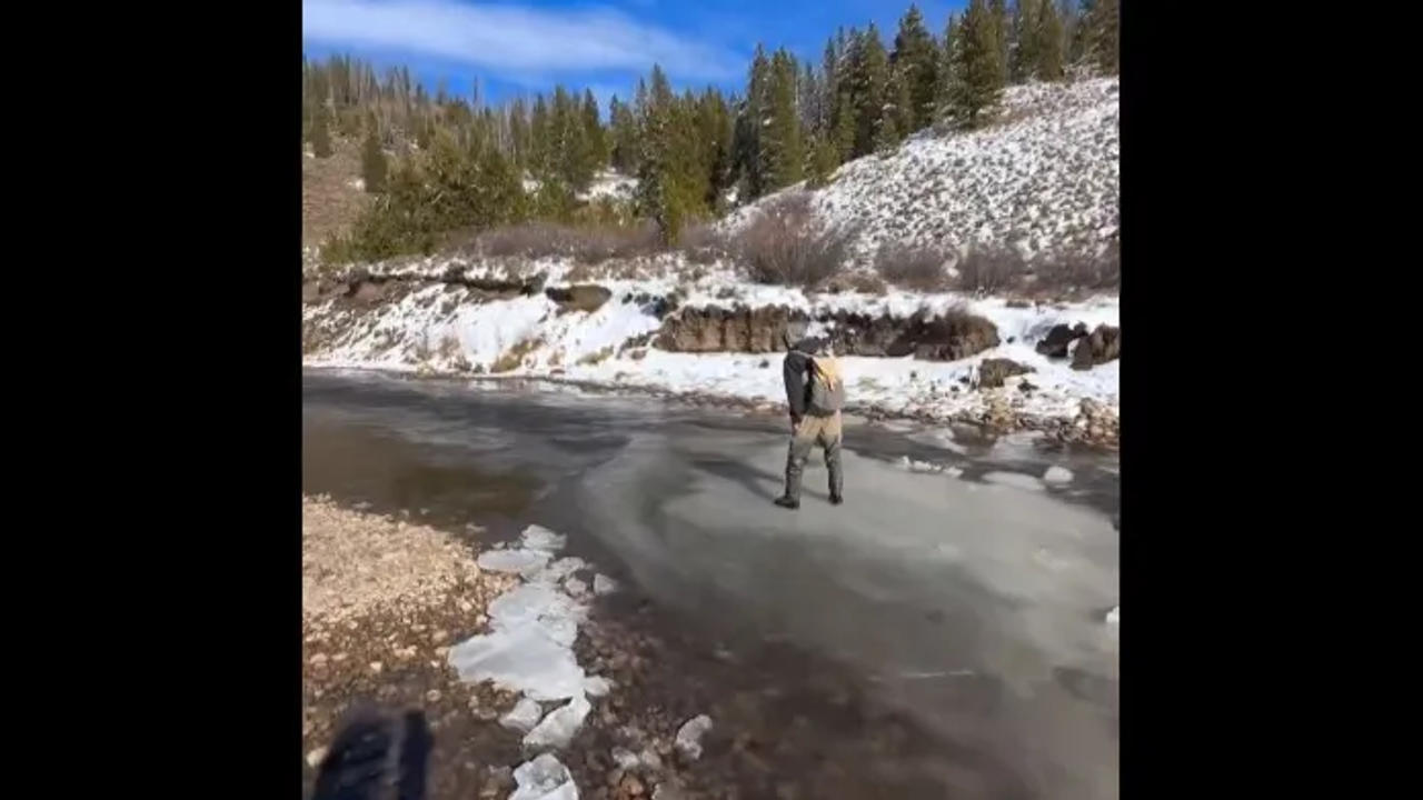  Man floats in river while standing on top of thin ice 