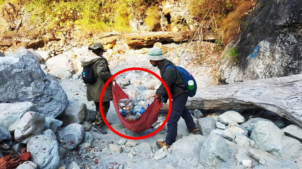 Forest range officer carrying trash collected from the forest 