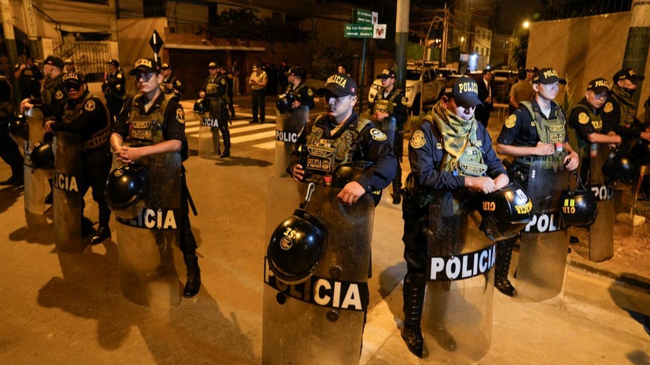 Police officers standing guard outside the Peruvian President's house during the raid on Saturday.