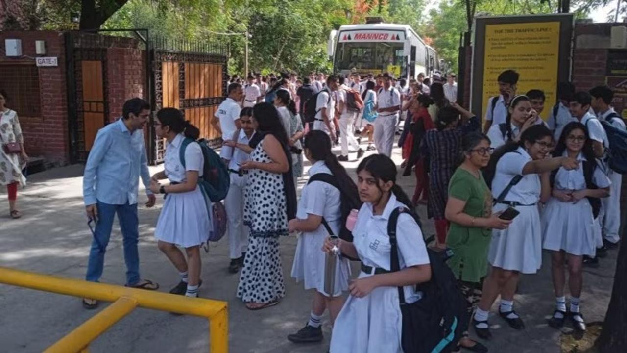  Students and parents outside Delhi Public School, Noida, after several schools received a bomb threat