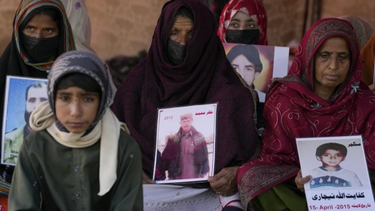 Baloch activists hold portraits of their missing family members during their sit-in protest, in Islamabad, Pakistan