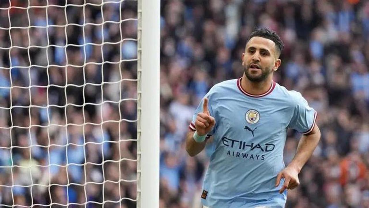 Man City beats Sheff United to keep treble dream alive