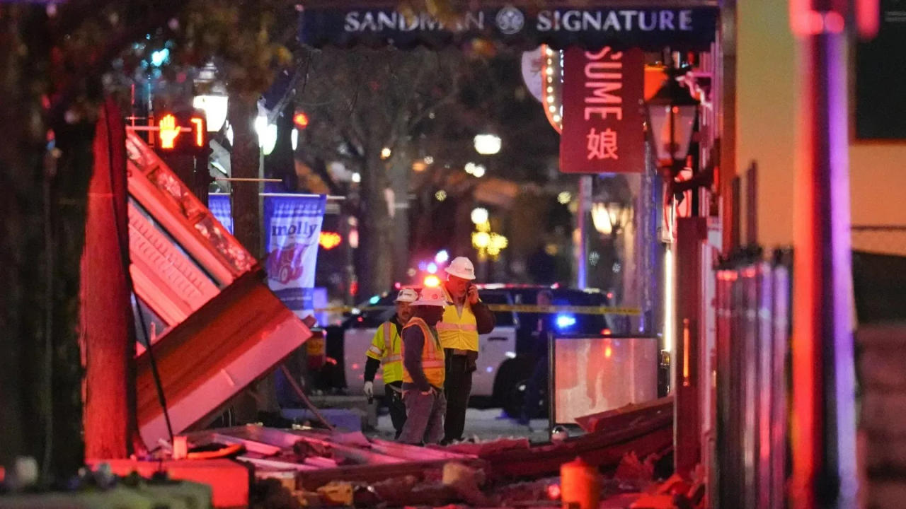 Workers survey damage near Sandman Signature hotel