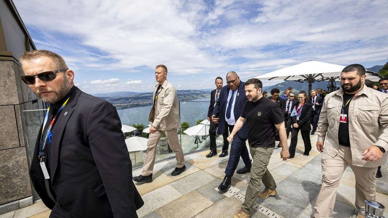 Ukrainian President Volodymyr Zelenskyy, centre, and Fiji's President Wiliame Maivalili Katonivere walk during the Summit on peace in Ukraine, in Obbürgen, Switzerland, June 16, 2024.