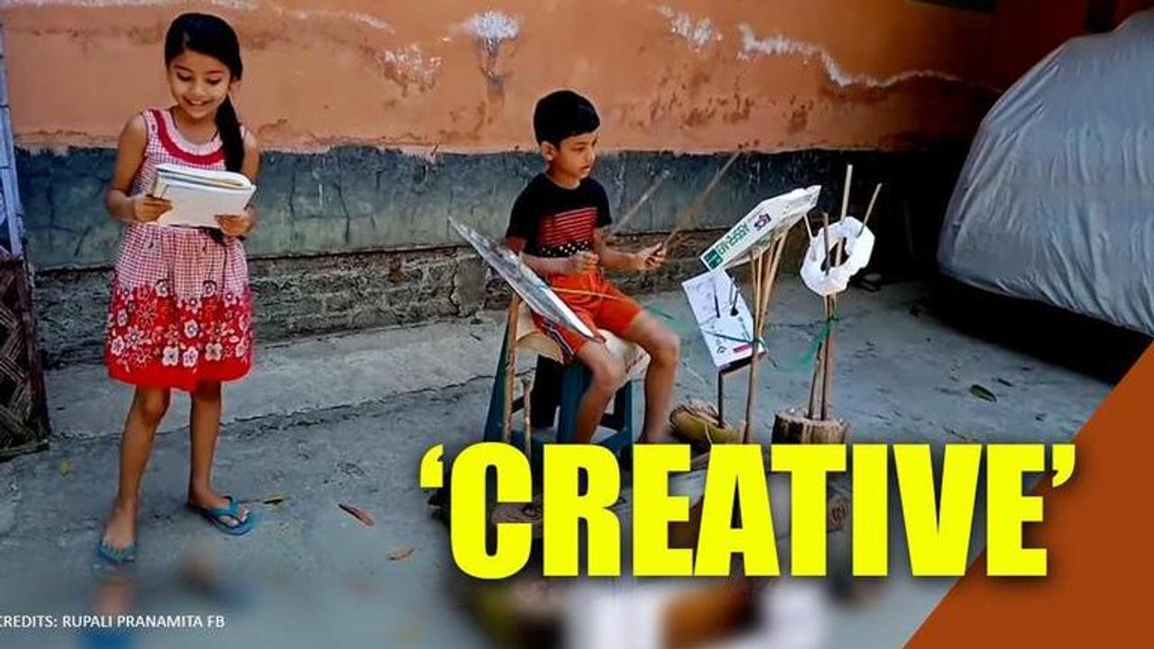 Siblings perform with drums made from cardboard and steel tray in Assam