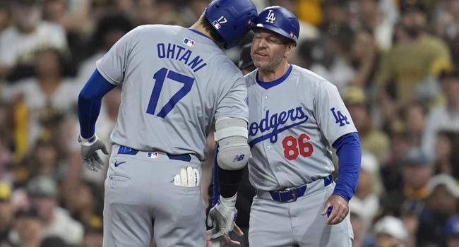 Los Angeles Dodgers’ Shohei Ohtani (17) celebrates with first base coach Clayton McCullough (86) 