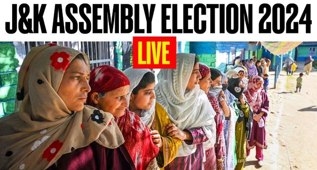 Women wait in a queue to cast his their votes at a polling booth during the first phase of Jammu and Kashmir Assembly elections, in Shopian district