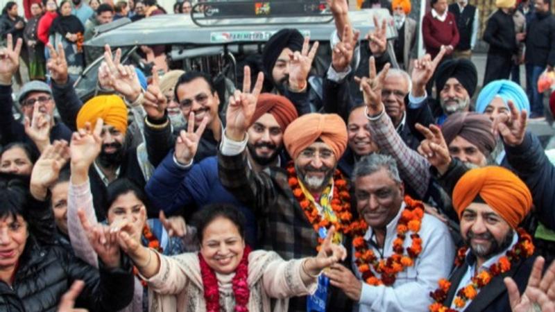 AAP candidate Gurjeet Singh Sahani and supporters celebrate following his victory in the Punjab Municipal Corporation Elections , in Patiala