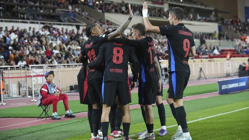 Barcelona players celebrate against Monaco.