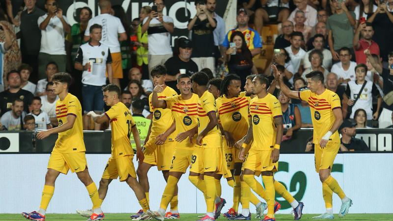 Barcelona players celebrate in their first La Liga game of the season against Valencia at Mestalla