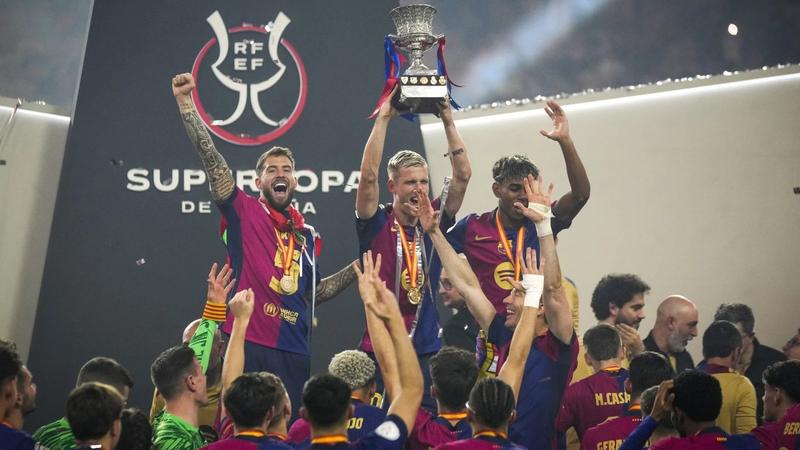 Barcelona players lift the trophy.