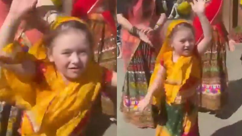 A young Russian girl, dressed in Indian attire, performing Bhangra