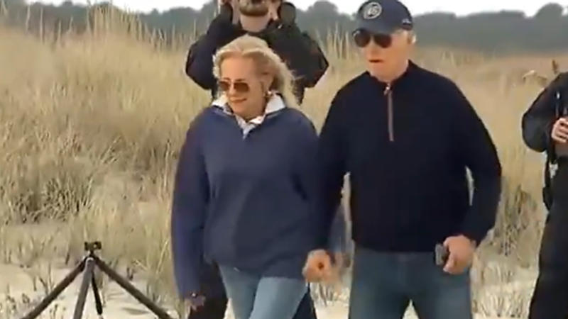 US President Joe Biden stumbles multiple times while walking on sandy beach in Delaware